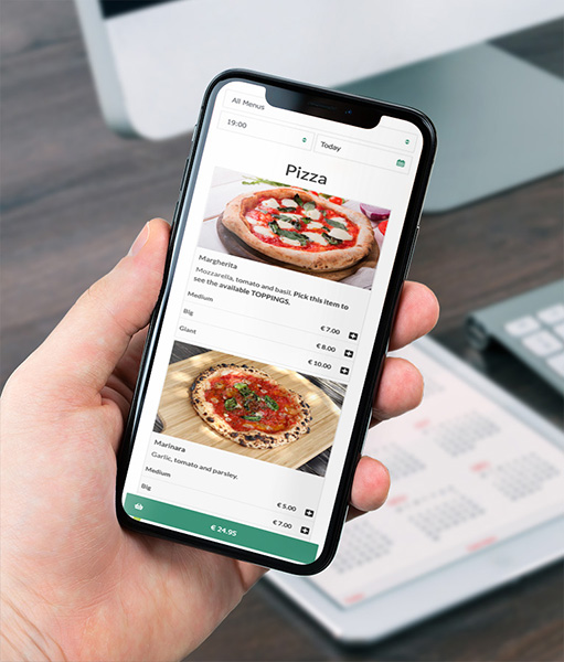 Hand holding a smartphone showing an online pizza menu with photos, sizes and prices for different pizzas.